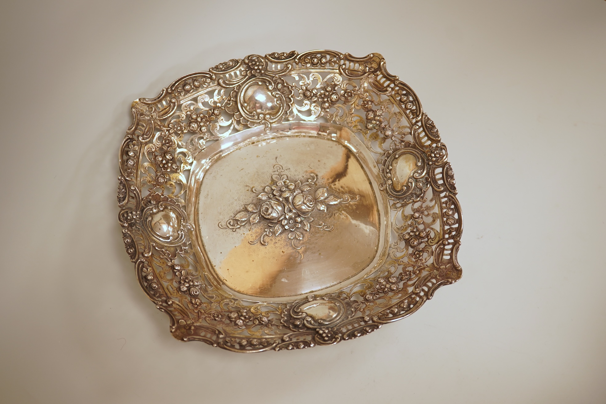 A pierced 800 standard white metal fruit bowl, diameter 23.6cm, a silver mounted hand mirror and two brushes, a 19th century continental white metal pyx, a pair of George V silver mounted whisky noggins, Birmingham, 1925